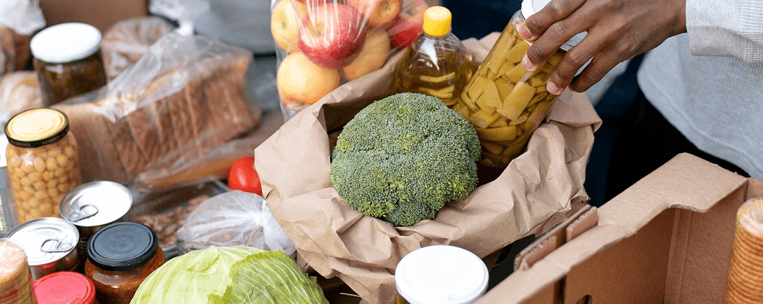 Various groceries including fresh vegetables and canned goods